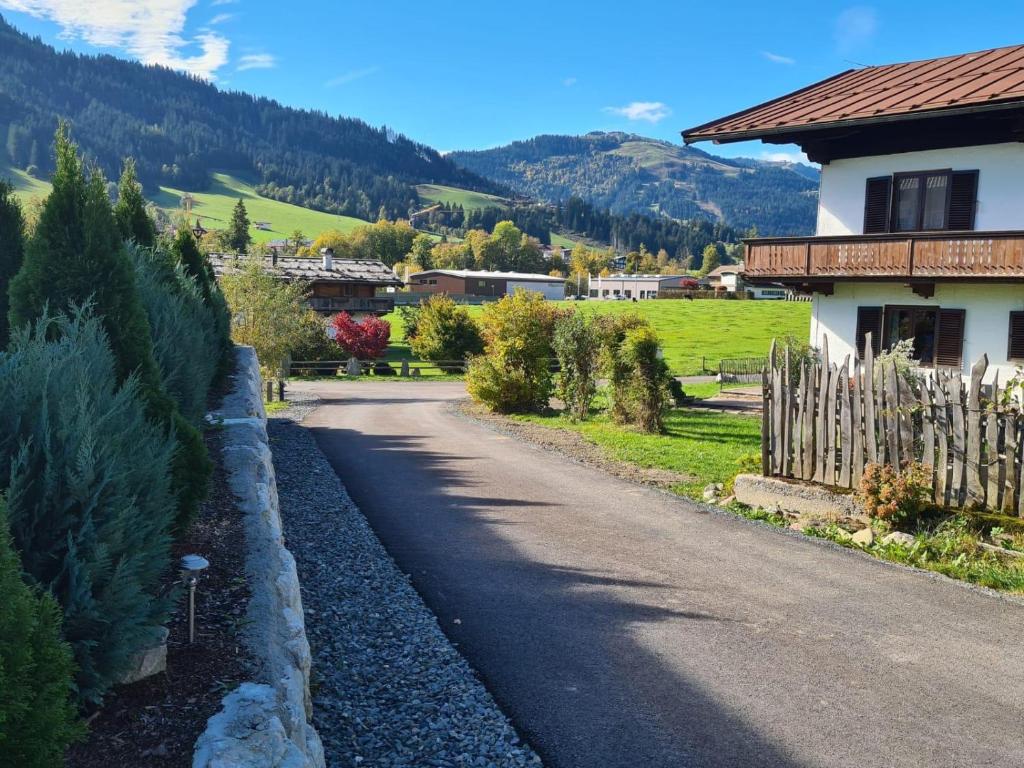 a road next to a house with a fence at Going EASY in Going