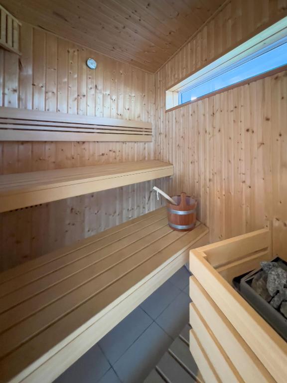 a wooden sauna with a bench and a sink at Peach on Beach Boutique Guesthouse in Bloubergstrand