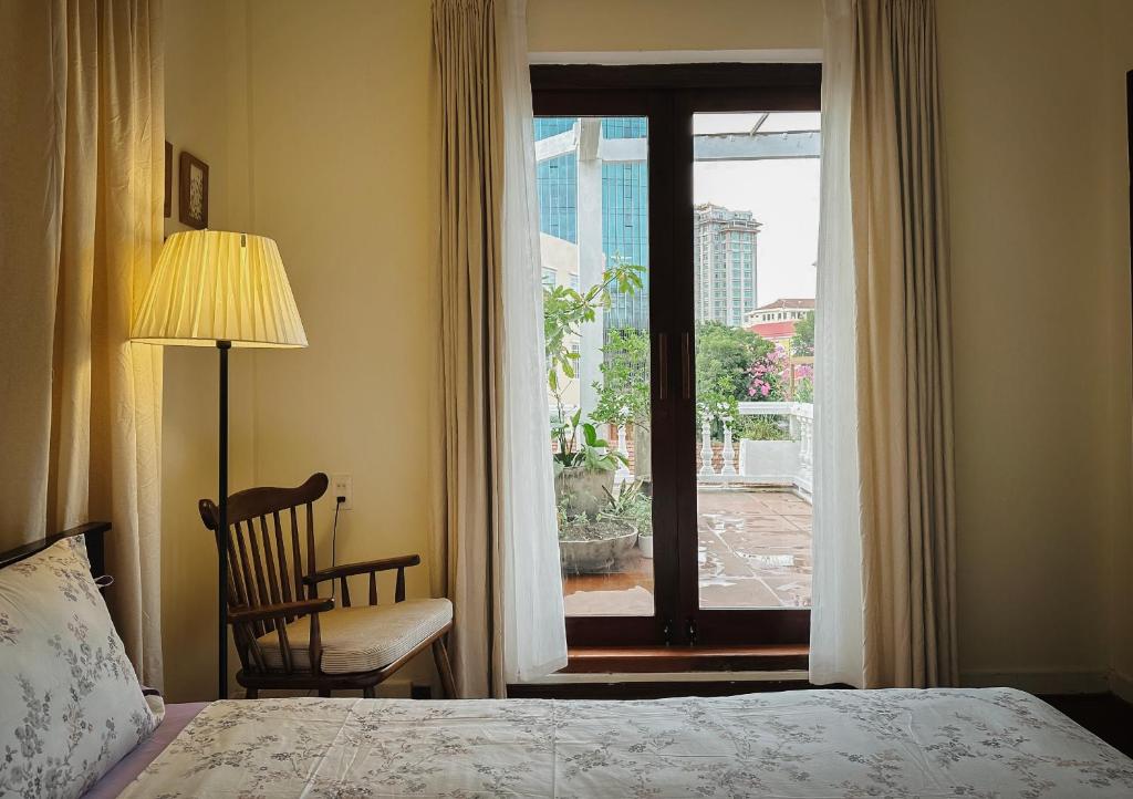 a bedroom with a bed and a window with a view at Forest Tag - 6/8 Ha Noi in Hue