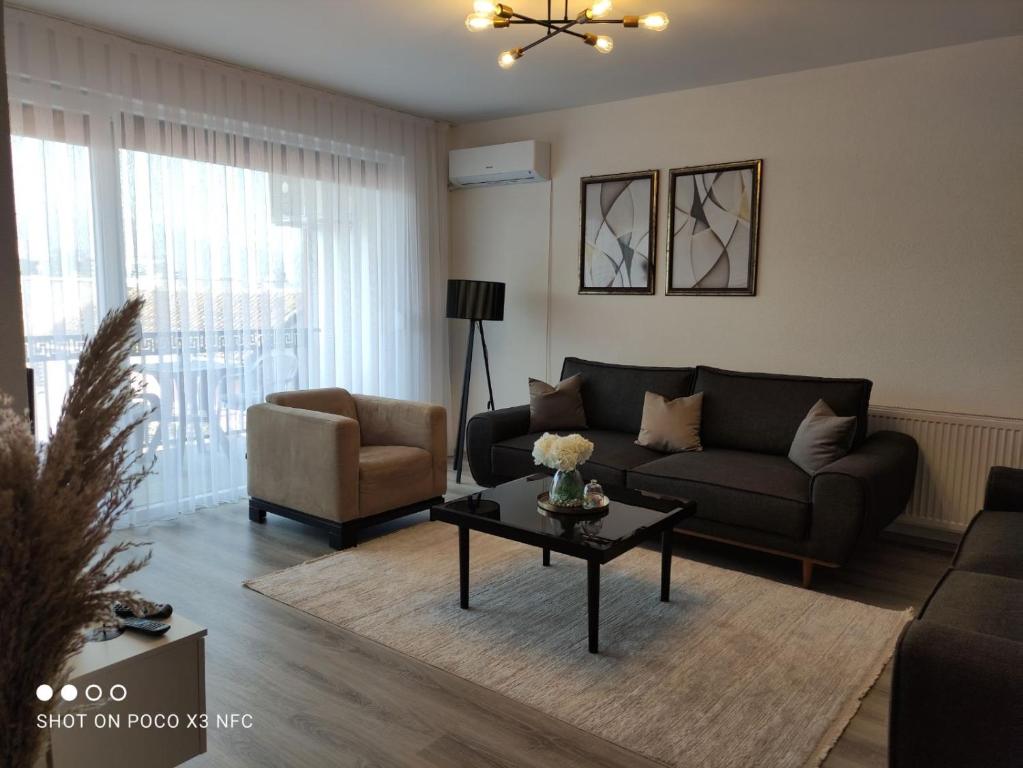 a living room with a couch and a table at Apartment Prizren New and Modern in Prizren