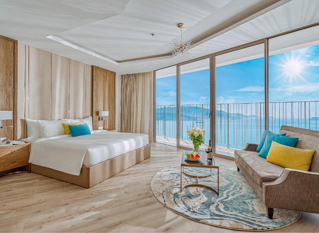 a hotel room with a bed and a couch at JK.Boutique Oceanfront Panorama Residence in Nha Trang