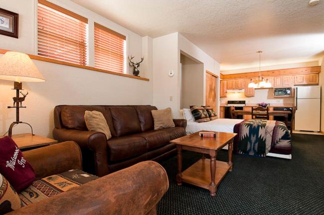 a living room with a couch and a table at Wildwood Inn in Estes Park