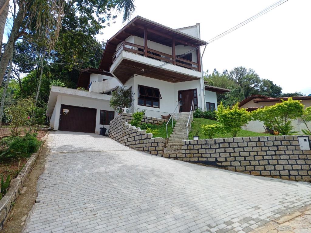 a house with a brick driveway in front of it at Residencial Rodrigues Florianópolis in Florianópolis