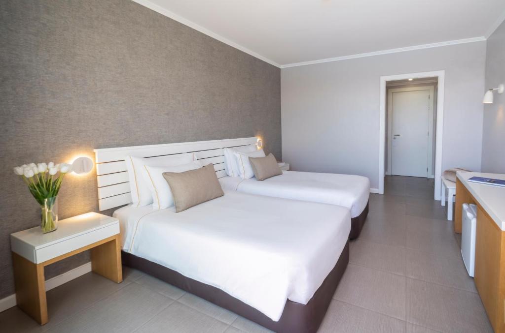 a hotel room with two beds and a sink at Arribas Sintra Hotel in Sintra