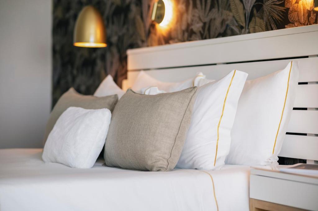 a bedroom with a white bed with pillows at Arribas Sintra Hotel in Sintra