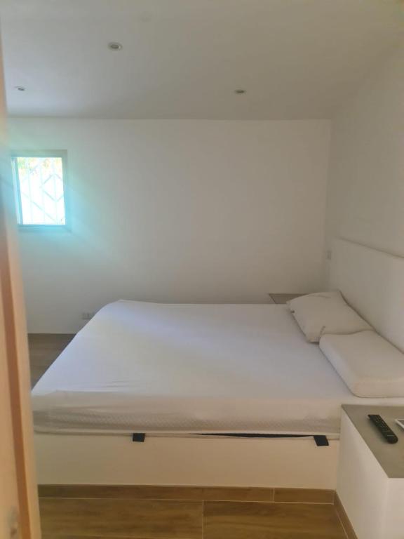 Een bed of bedden in een kamer bij Le Dune di Circe