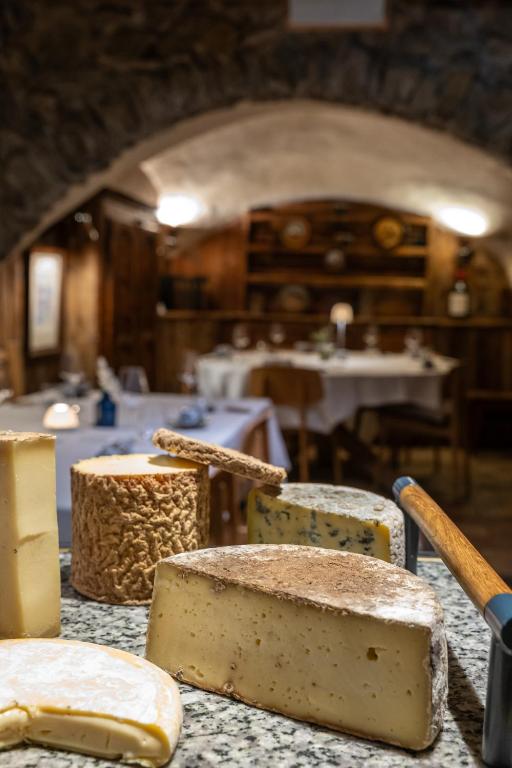 a table with cheeses on top of a counter at Au Coin Du Feu in Megève