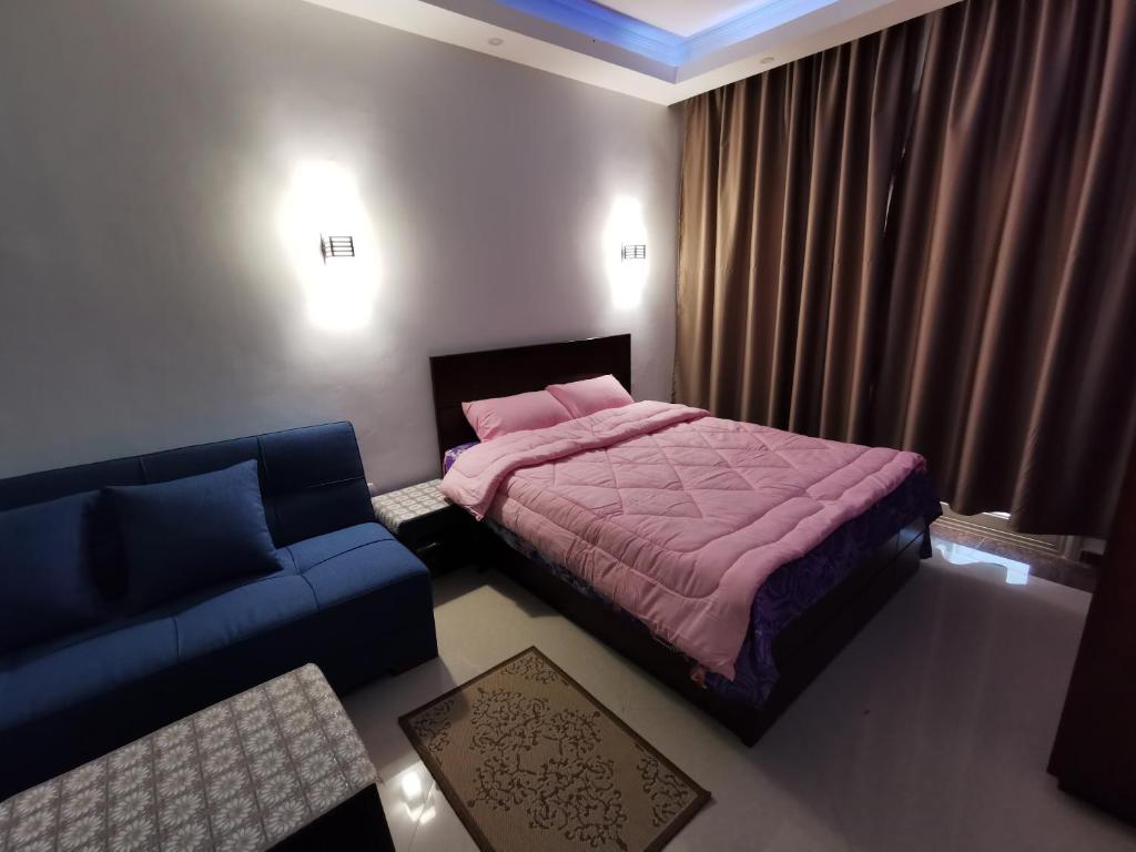 a bedroom with a bed and a couch at Cecelia resort in Hurghada