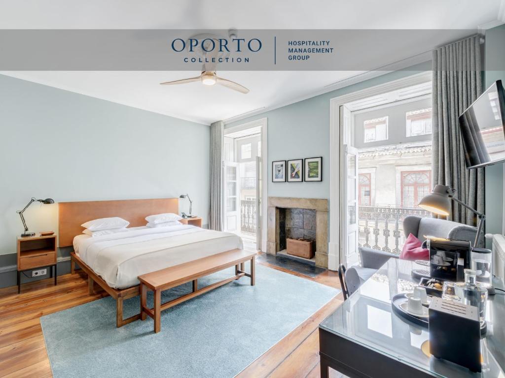 a bedroom with a bed and a fireplace at Rosário Suites Townhouse, by Oporto Collection in Porto