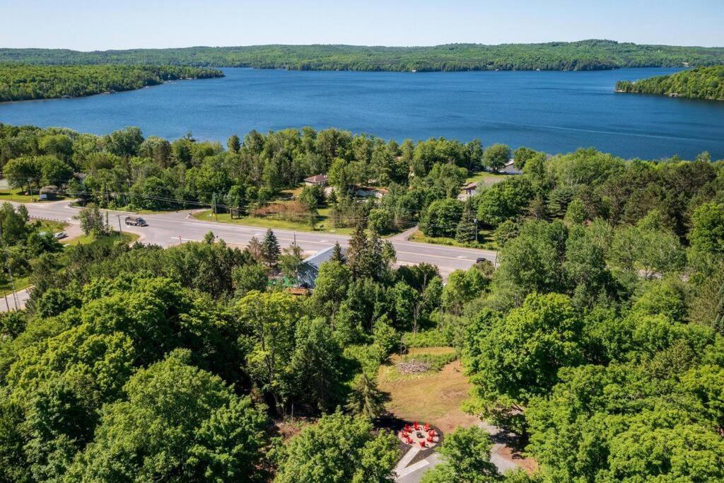 an aerial view of a road and a lake at Deer Den cottage in Huntsville in Huntsville