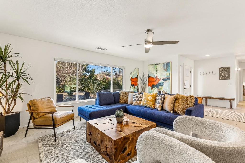 a living room with a blue couch and chairs at Trendy 3BR in Sedona: Hot Tub/Fire-pit /Central Location in Sedona