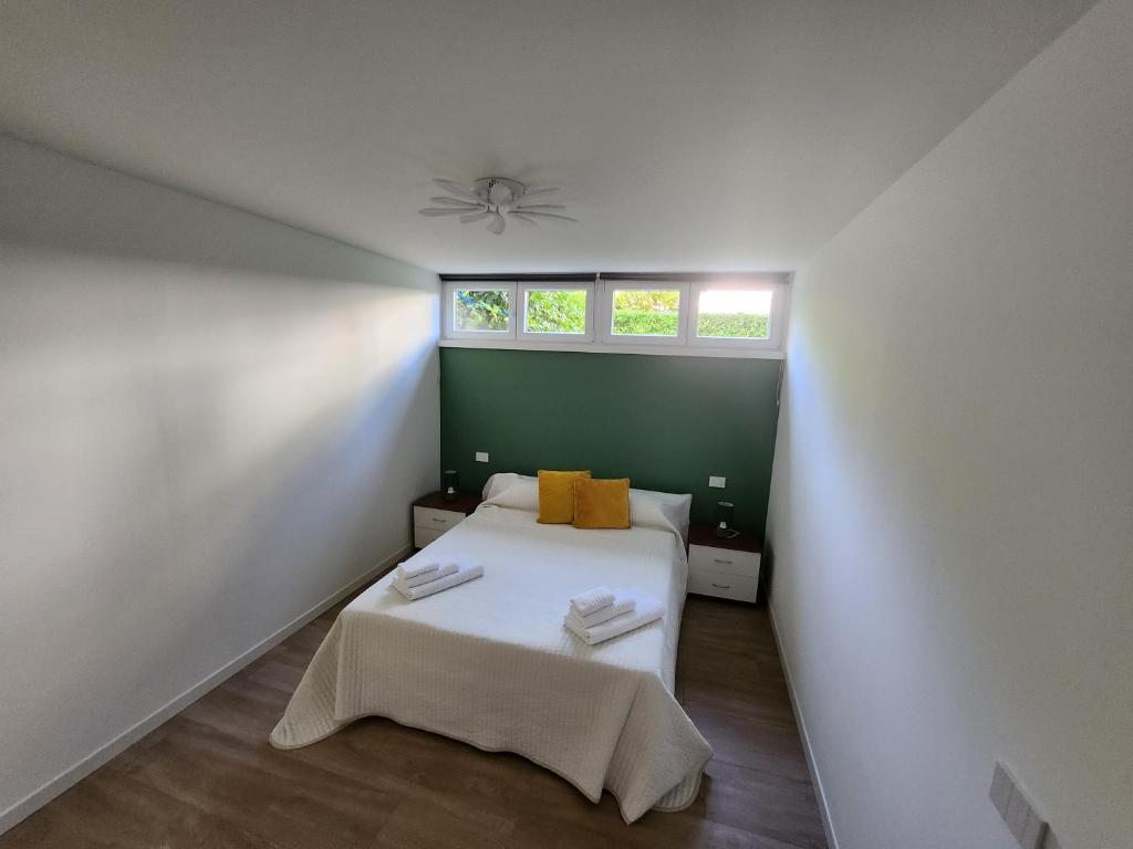 a small bedroom with a bed and a window at CASA CLEO in Udine