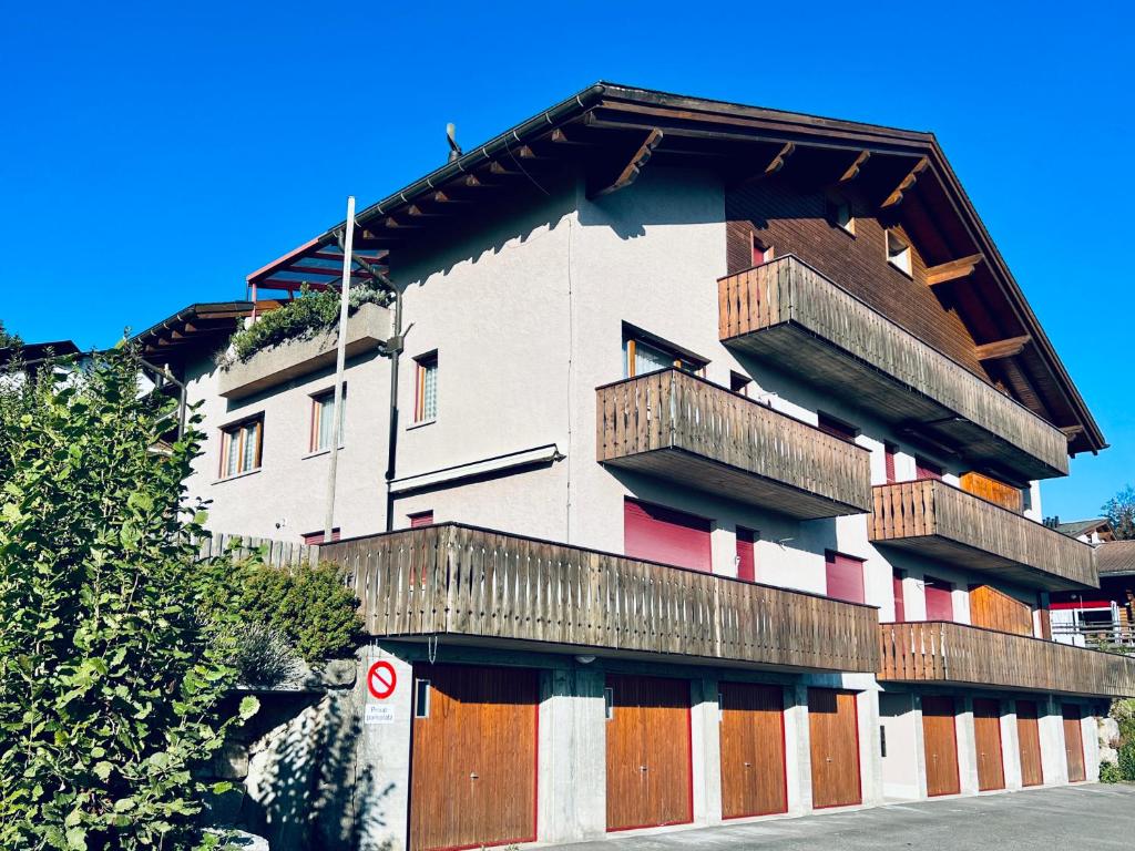 a building with wooden balconies on the side of it at Steinbock 2OG - CharmingStay in Flumserberg