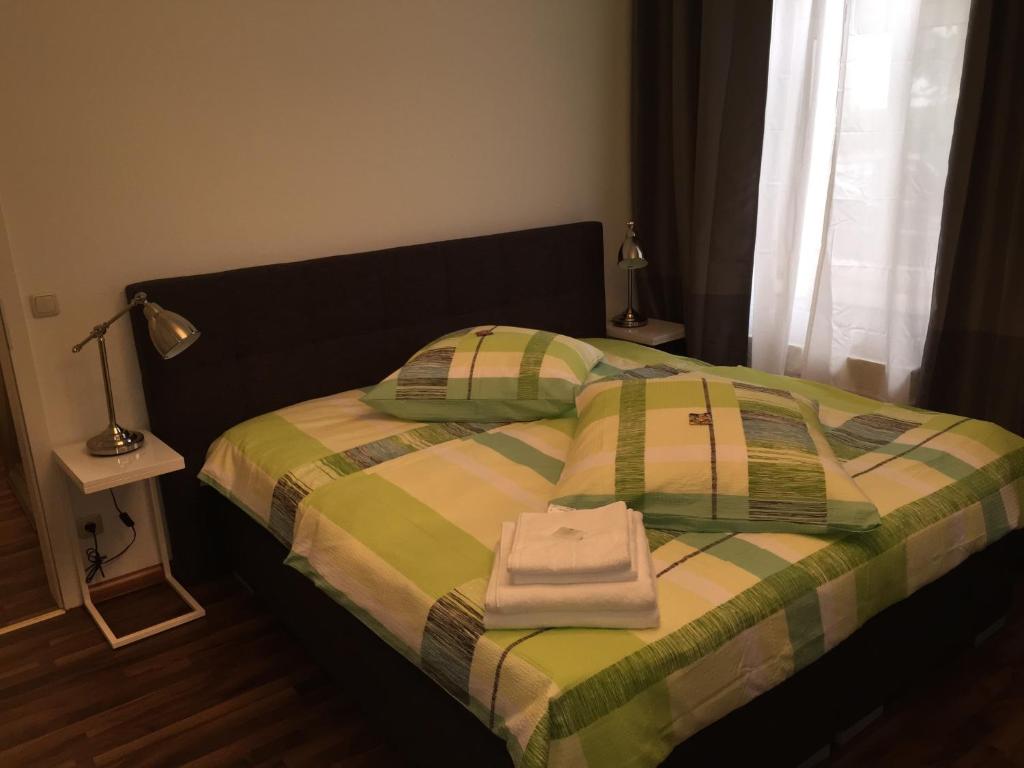 a bedroom with a bed with two towels on it at Elbsandstein Apartments Altstadt in Erfurt