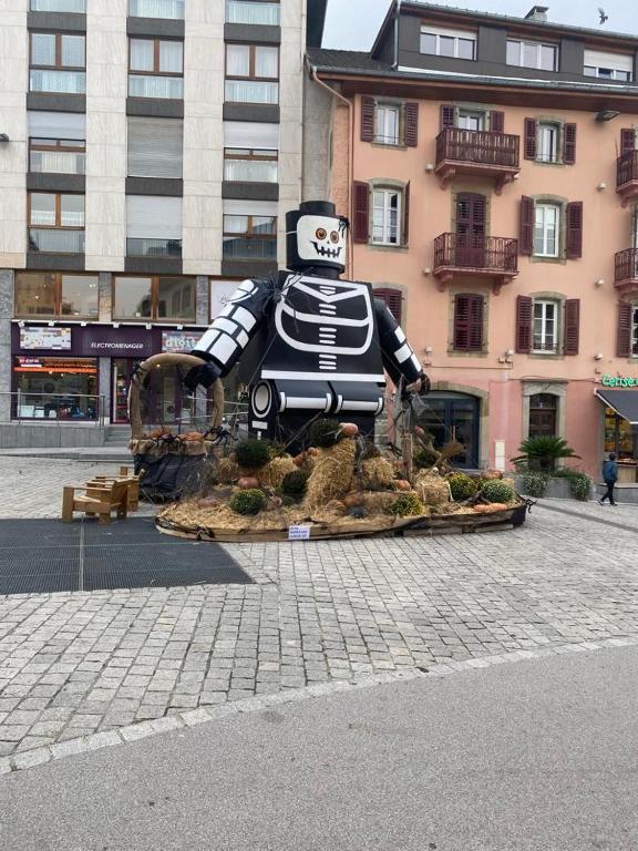 Hotel Mandana, a statue of a character sitting in the middle of a city at Mandana in Évian-les-Bains