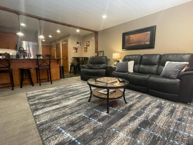 a living room with a couch and a table at Penthouse Mountain Haven with Community Spa Room in Kellogg