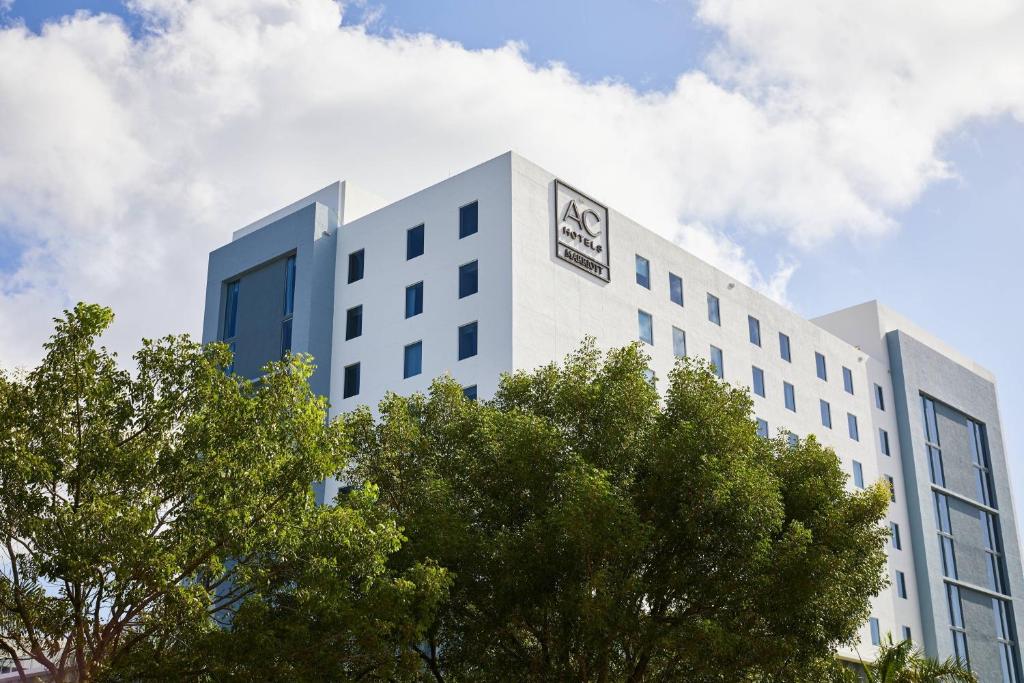 a white building with a sign on the side of it at AC Hotel by Marriott Miami Aventura in Aventura