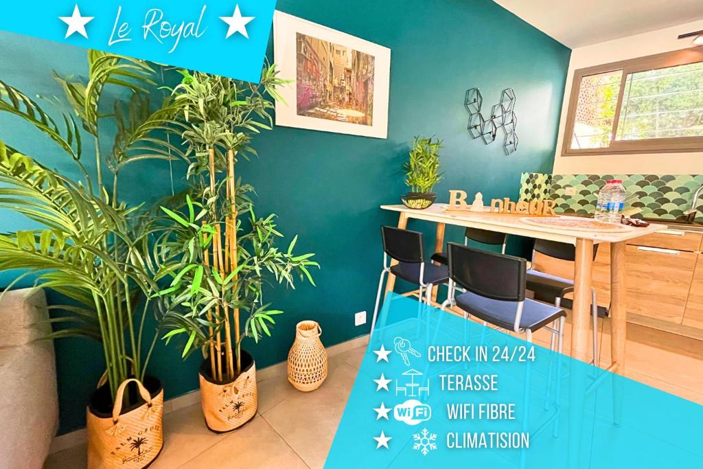 a dining room with plants and a table with a blue wall at *Le Royal*Havre De Paix*Wifi* in Marseille