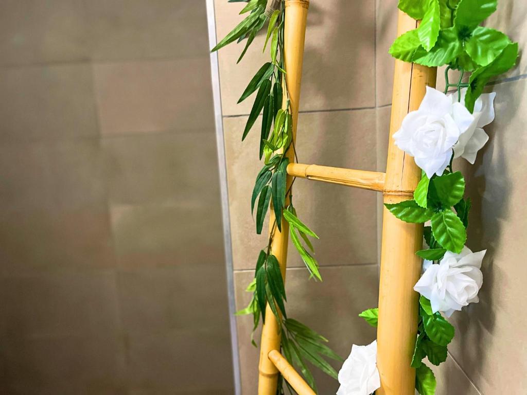 a bamboo ladder with white flowers on it at *Le Royal*Havre De Paix*Wifi* in Marseille