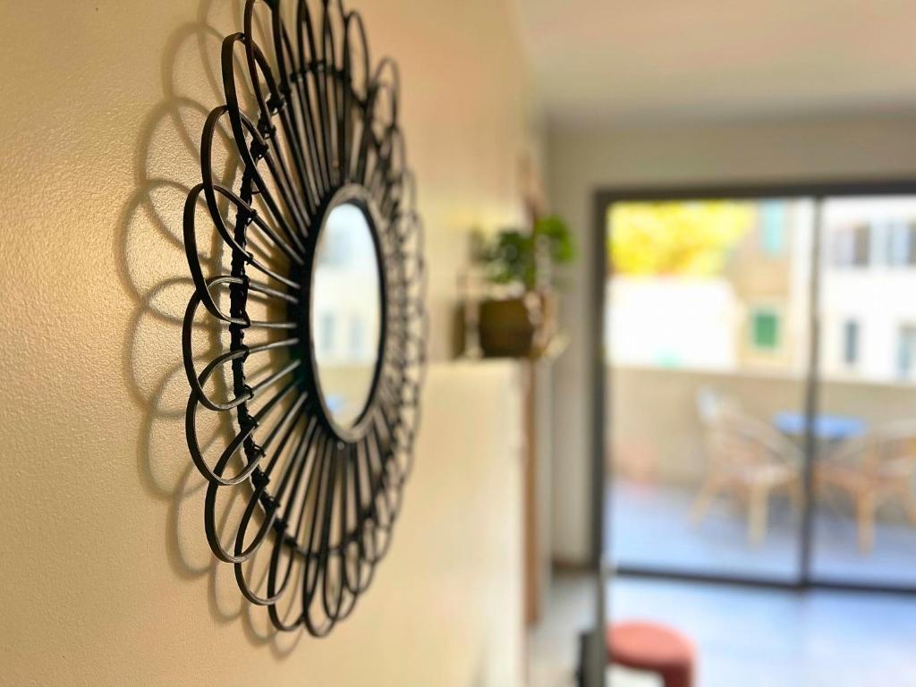 a mirror hanging on a wall in a living room at *Le Royal*Havre De Paix*Wifi* in Marseille