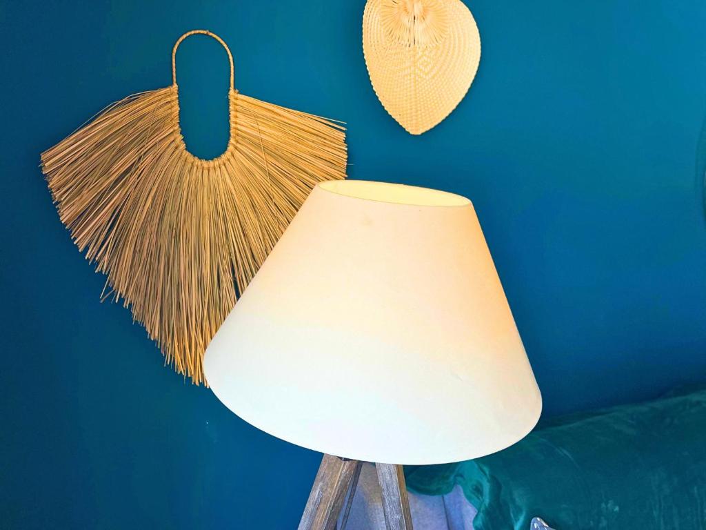 a white lamp with a tasselinylinylinylinylinylinylinylinyl at *Le Royal*Havre De Paix*Wifi* in Marseille