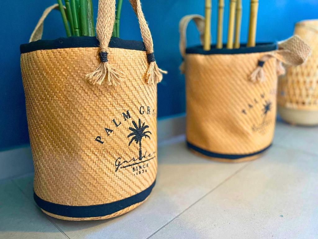 three straw bags with a palm tree on them at *Le Royal*Havre De Paix*Wifi* in Marseille
