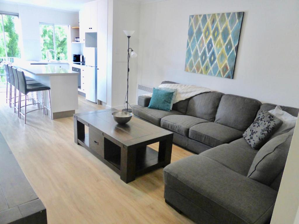 a living room with a couch and a table at View Street Vista location parking and views in Sandy Bay