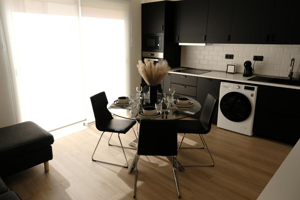 a kitchen with a table and chairs in a room at Urban Oasis La Palma in Santa Cruz de la Palma