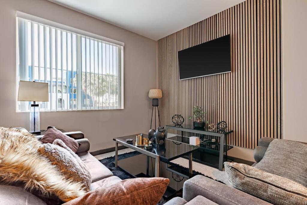 a living room with a couch and a tv at Private, Modern Luxury 2 Bd/ 2 Ba in Santa Ana