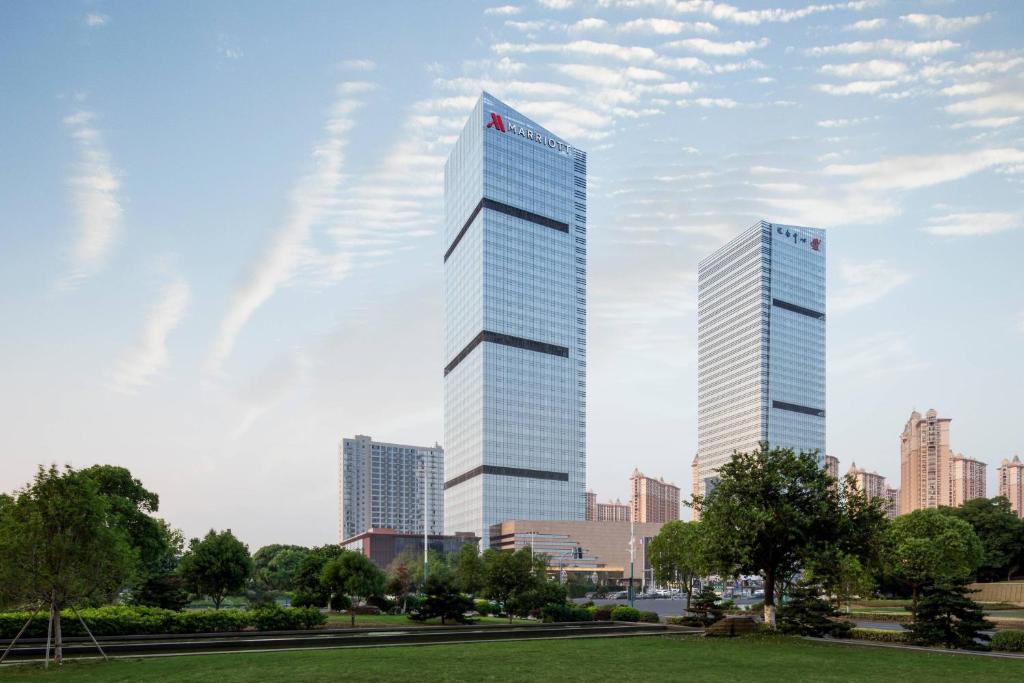 a rendering of two tall buildings in a city at Zhangjiagang Marriott Hotel in Zhangjiagang