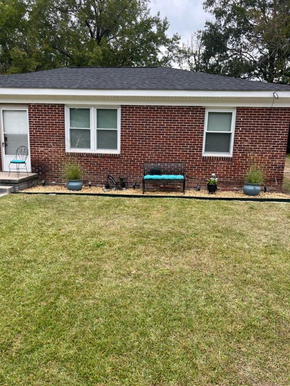 a brick house with a bench in the yard at Home Sweet Home in Columbia