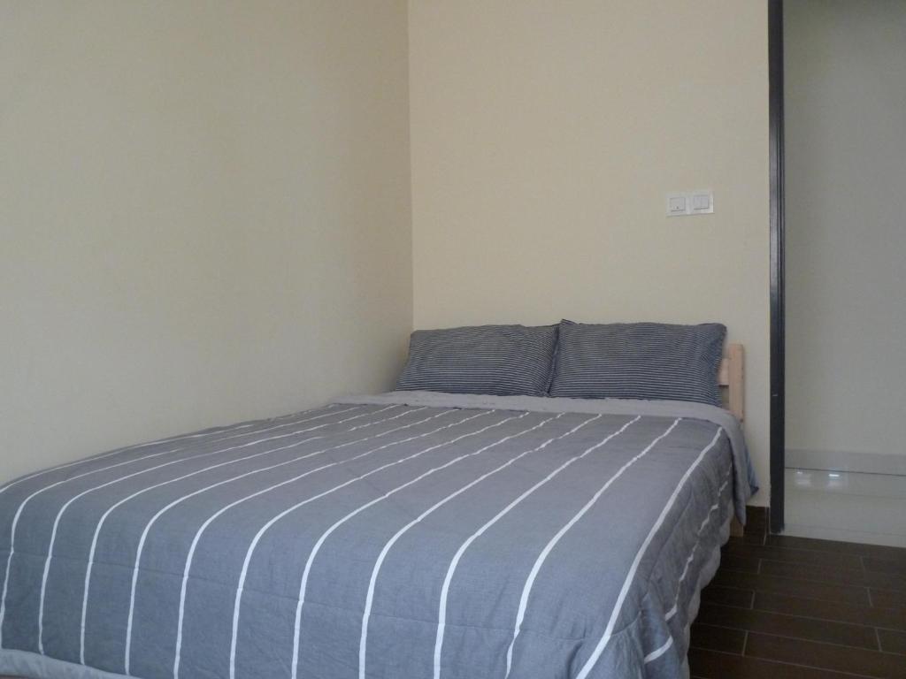 Postel nebo postele na pokoji v ubytování Jome Putrajaya Presint 8 Natural Homestay