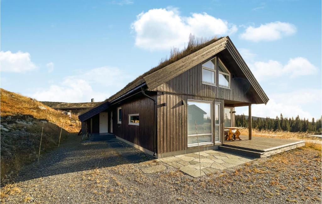 a small wooden house with a grass roof at 4 Bedroom Lovely Home In Lillehammer in Lillehammer