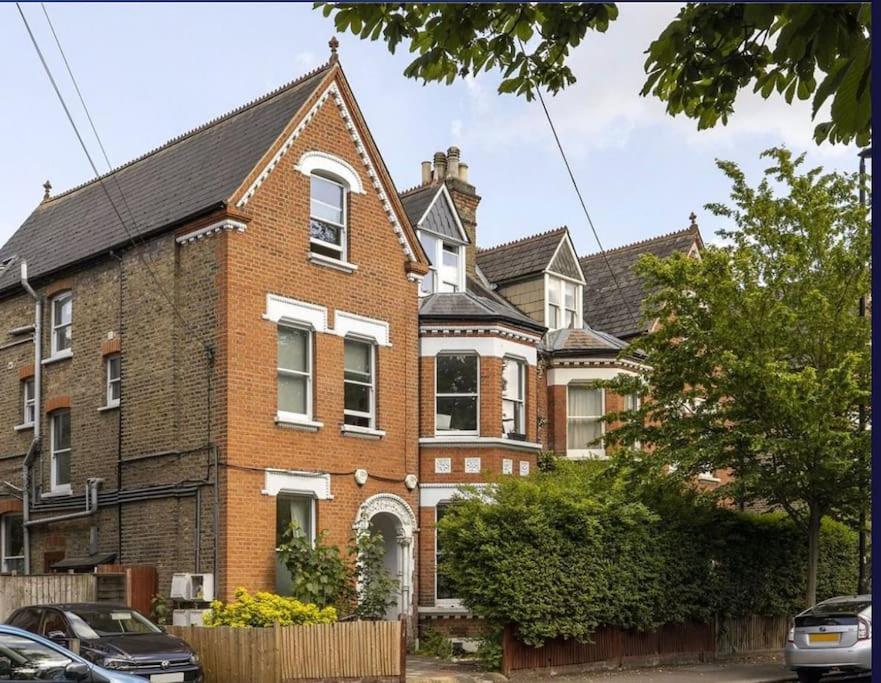 a large brick house in a residential neighborhood at 2 bed garden flat West Dulwich FREE STREET PARKING in London