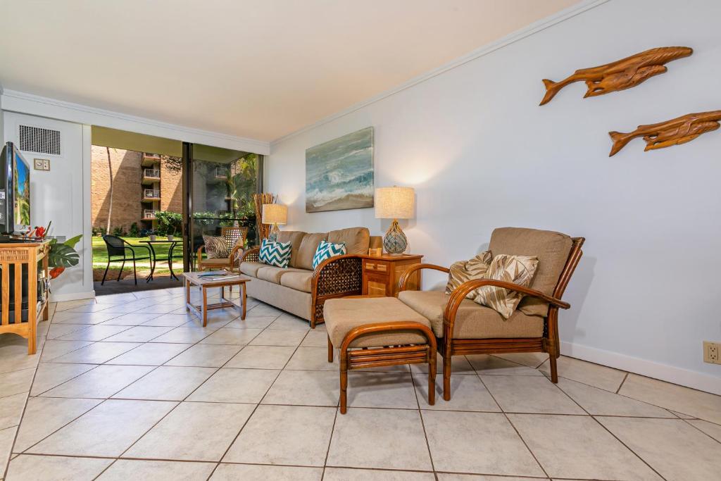 a living room with chairs and a couch at Kauhale Makai 122 in Kihei