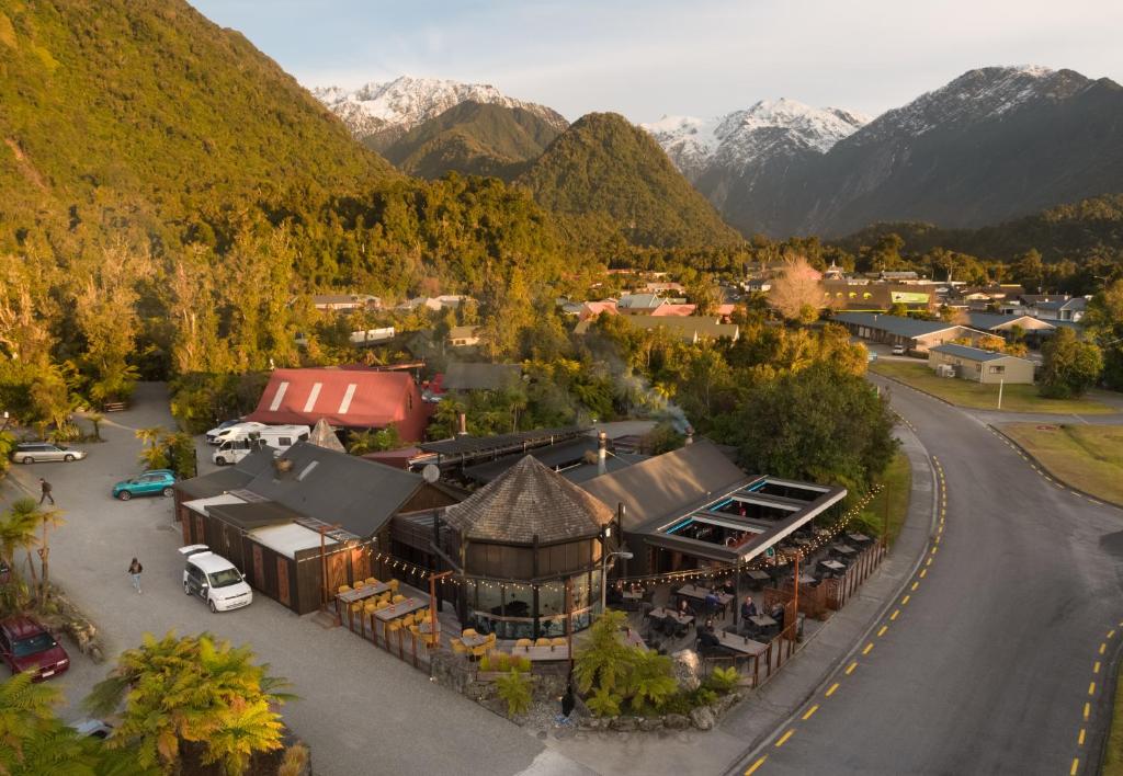 an aerial view of a town with mountains in the background at Rainforest Retreat in Franz Josef