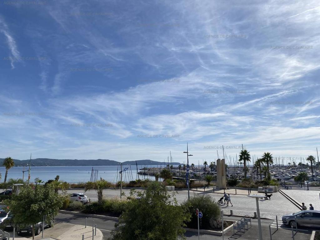 a view of a parking lot with a body of water at Appartement climatisé face mer, avec piscine et parking, Cavalaire-sur-Mer - FR-1-100-320 in Cavalaire-sur-Mer