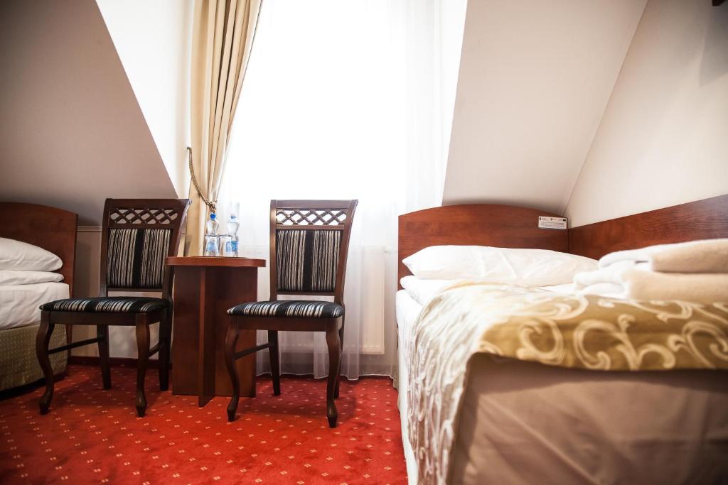 Posteľ alebo postele v izbe v ubytovaní Hotel Stara Gorzelnia