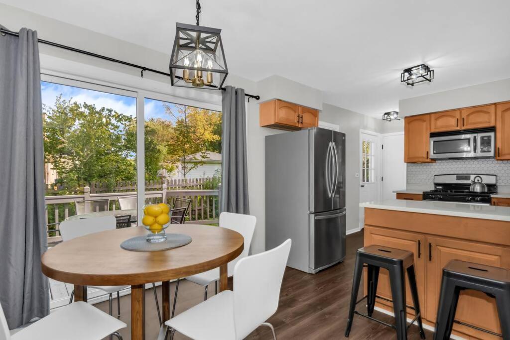 a kitchen and dining room with a table and chairs at Prime Location, Cozy & Spacious home in Schaumburg in Schaumburg
