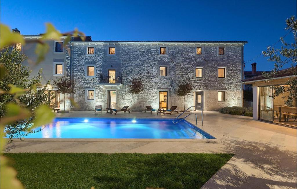 a house with a swimming pool in front of a building at Villa Simeanna in Kringa
