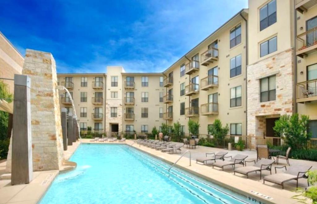 an image of a swimming pool in front of a building at Modern comfort at The Domain Austin ,Texas in Austin