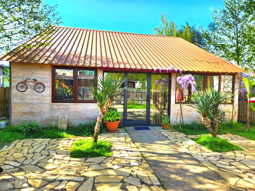 a house with a gate and a stone patio at House & Yard Sesil XL 90m to beach in Ureki