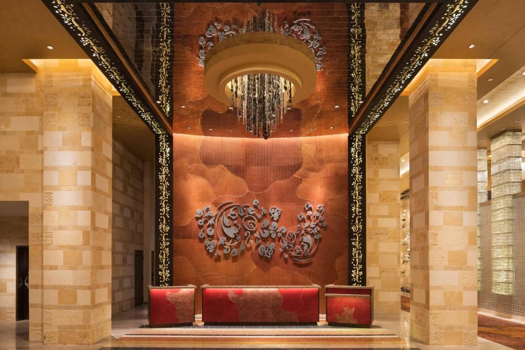 a bench in a lobby with a chandelier at The Westin Nashville in Nashville