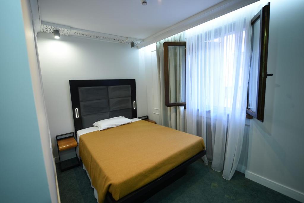 Postel nebo postele na pokoji v ubytování Hotel Celis