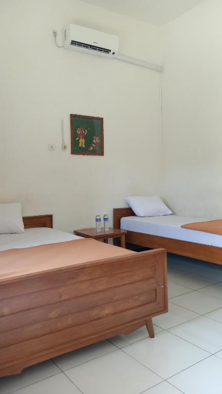 Postel nebo postele na pokoji v ubytování Hotel Tentrem Syariah