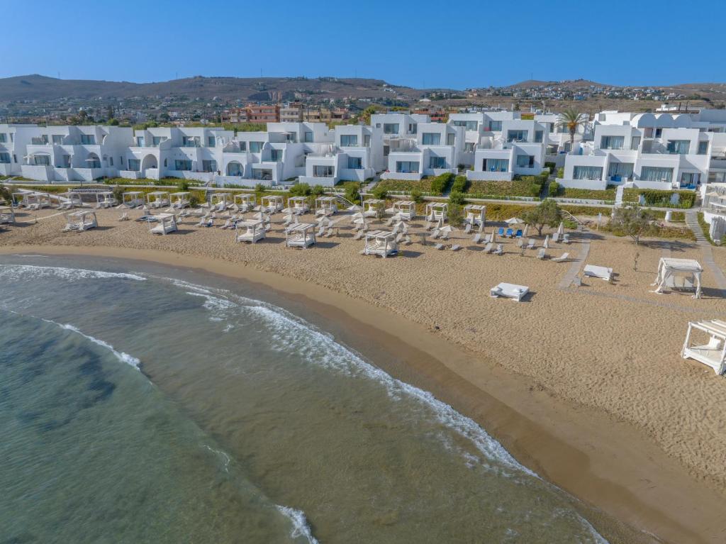 an aerial view of a beach with chairs and the ocean at Knossos Beach Bungalows Suites Resort & Spa in Kokkini Khanion