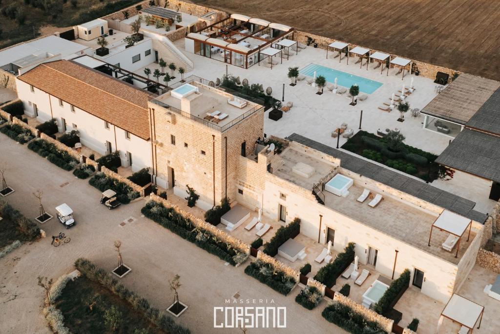 an aerial view of a building with a pool at Masseria Corsano in Nardò