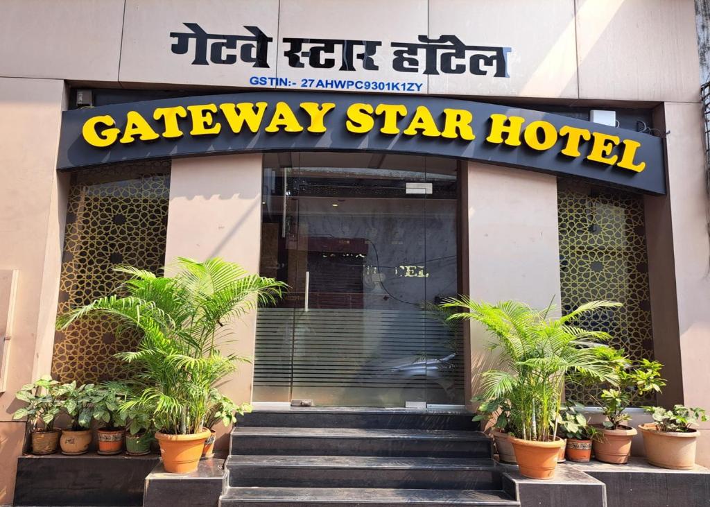 a cataway star hotel with potted plants in front of it at GATEWAY STAR HOTEL in Mumbai