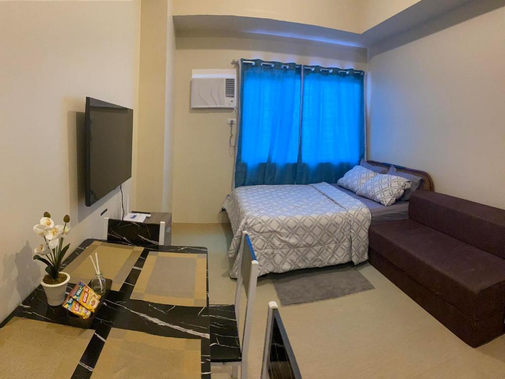 a small room with a bed and a couch at Fully furnishd Avida condo 2(wi-fi netflx disney+) in Cagayan de Oro