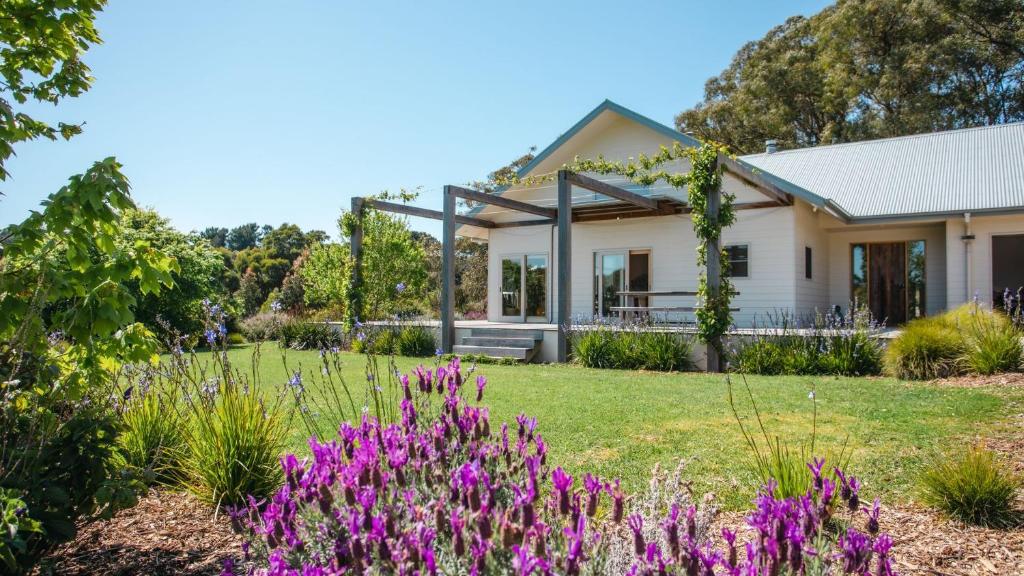 a house with purple flowers in the yard at Hayduke in Red Hill South
